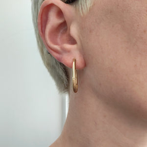 Italian 9ct Yellow Gold Oval Textured Hoop Earrings modelled in the ear