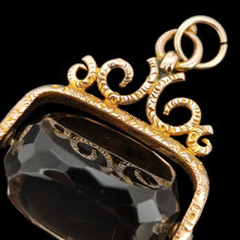 Load image into Gallery viewer, A spinning quartz fob pendant in yellow gold, on a black background

