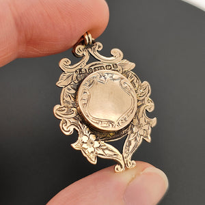 Edwardian 9ct Rose Gold Hidden Locket Fob Medal in hand