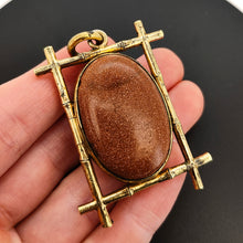 Load image into Gallery viewer, Large Antique Goldstone and Rock Crystal Locket in hand
