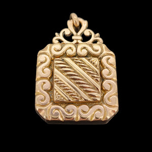 Antique Rolled Gold Ornate Locket Pendant shown from the back, on a black background