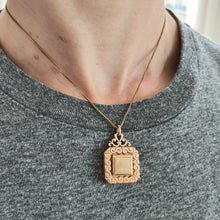 Load image into Gallery viewer, Antique Rolled Gold Ornate Locket Pendant modelled with a gold chain

