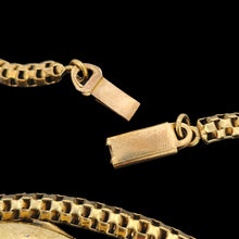 Load image into Gallery viewer, A close-up of a yellow metal chain with a box clasp, on a black background
