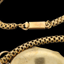 Load image into Gallery viewer, A close-up of a yellow metal chain with a box clasp, on a black background
