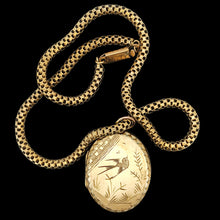 Load image into Gallery viewer, An oval locket with bird engraving with a Venetian link chain in yellow metal, on a black background
