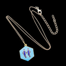 Load image into Gallery viewer, A hexagonal Gemini star sign pendant in blue enamel, with a chain
