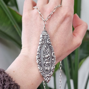 Antique Sterling Silver Floral Pendant with Sterling Silver Chain in hand