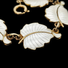 Load image into Gallery viewer, A white enamel leaf necklace in silver gilt, close-up
