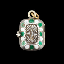 Load image into Gallery viewer, Silver pendant with green and white enamel accents on a black background
