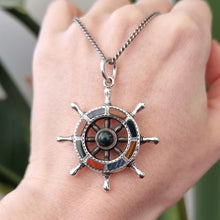 Load image into Gallery viewer, Victorian Silver Scottish Agate Ship&#39;s Wheel Pendant in hand with chain
