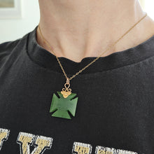 Load image into Gallery viewer, Victorian 9ct Gold Nephrite Jade Cross Pattée Pendant modelled with a gold chain against a black t-shirt
