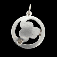 Load image into Gallery viewer, A silver triskelion pendant, on a black background
