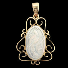 Load image into Gallery viewer, An oval yellow gold and mother of pearl pendant carved with a bird, on a black background
