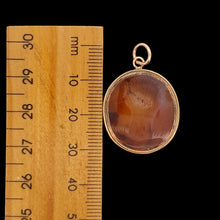 Load image into Gallery viewer, An oval carnelian intaglio pendant displaying a wheatsheaf, next to a ruler
