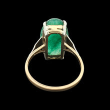 Load image into Gallery viewer, An oval nephrite jade ring in white and yellow gold, on a black background
