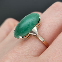 Load image into Gallery viewer, An oval nephrite jade ring in white and yellow gold, modelled on a hand
