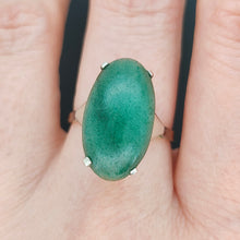 Load image into Gallery viewer, An oval nephrite jade ring in white and yellow gold, modelled on a hand
