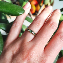 Load image into Gallery viewer, An emerald and diamond graduated five stone ring in yellow gold, modelled on a hand
