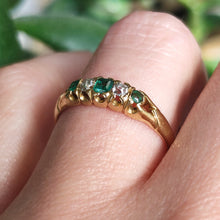 Load image into Gallery viewer, An emerald and diamond graduated five stone ring in yellow gold, modelled on a hand
