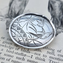 Load image into Gallery viewer, Victorian Silver Swallow Bird Plaque Brooch on book page

