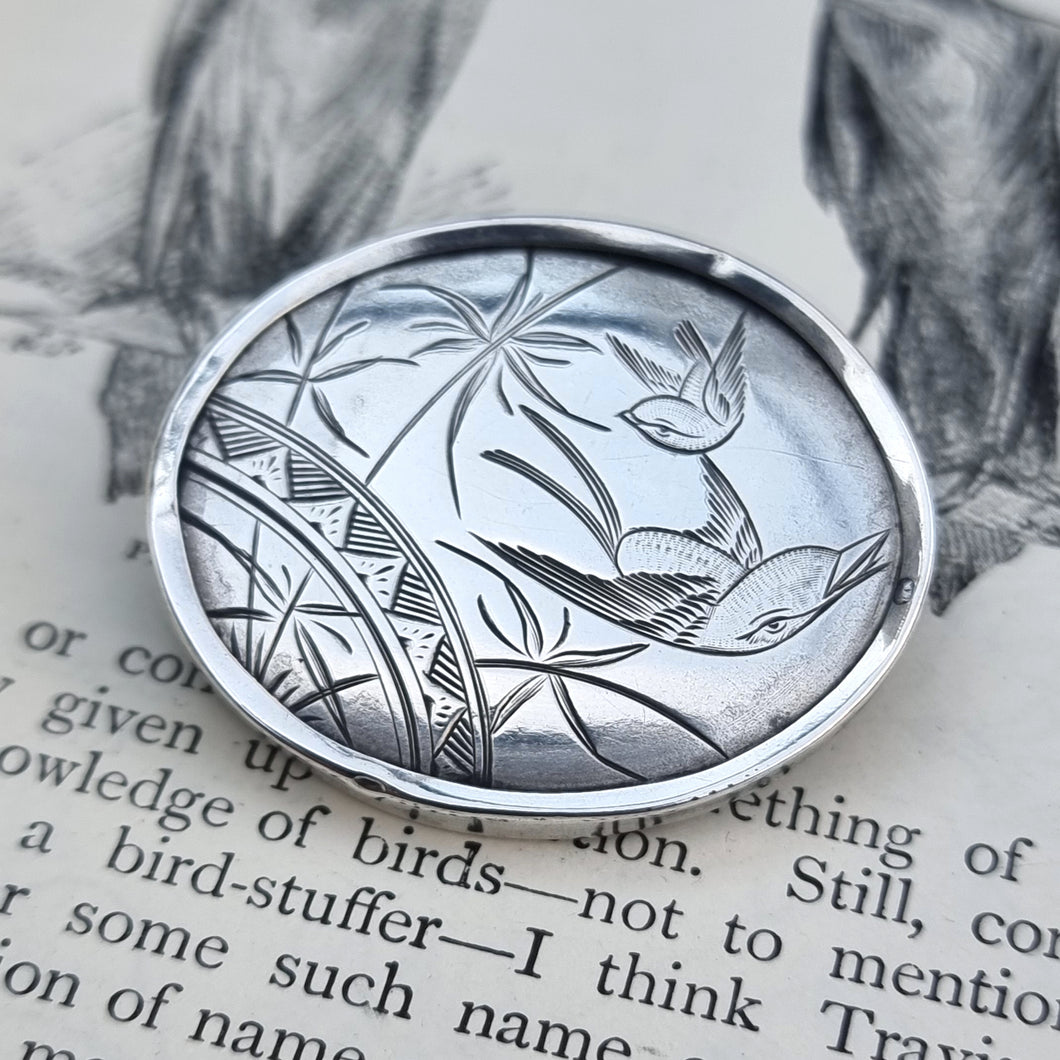 Victorian Silver Swallow Bird Plaque Brooch on book page