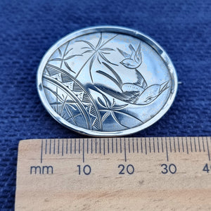 Victorian Silver Swallow Bird Plaque Brooch next to ruler